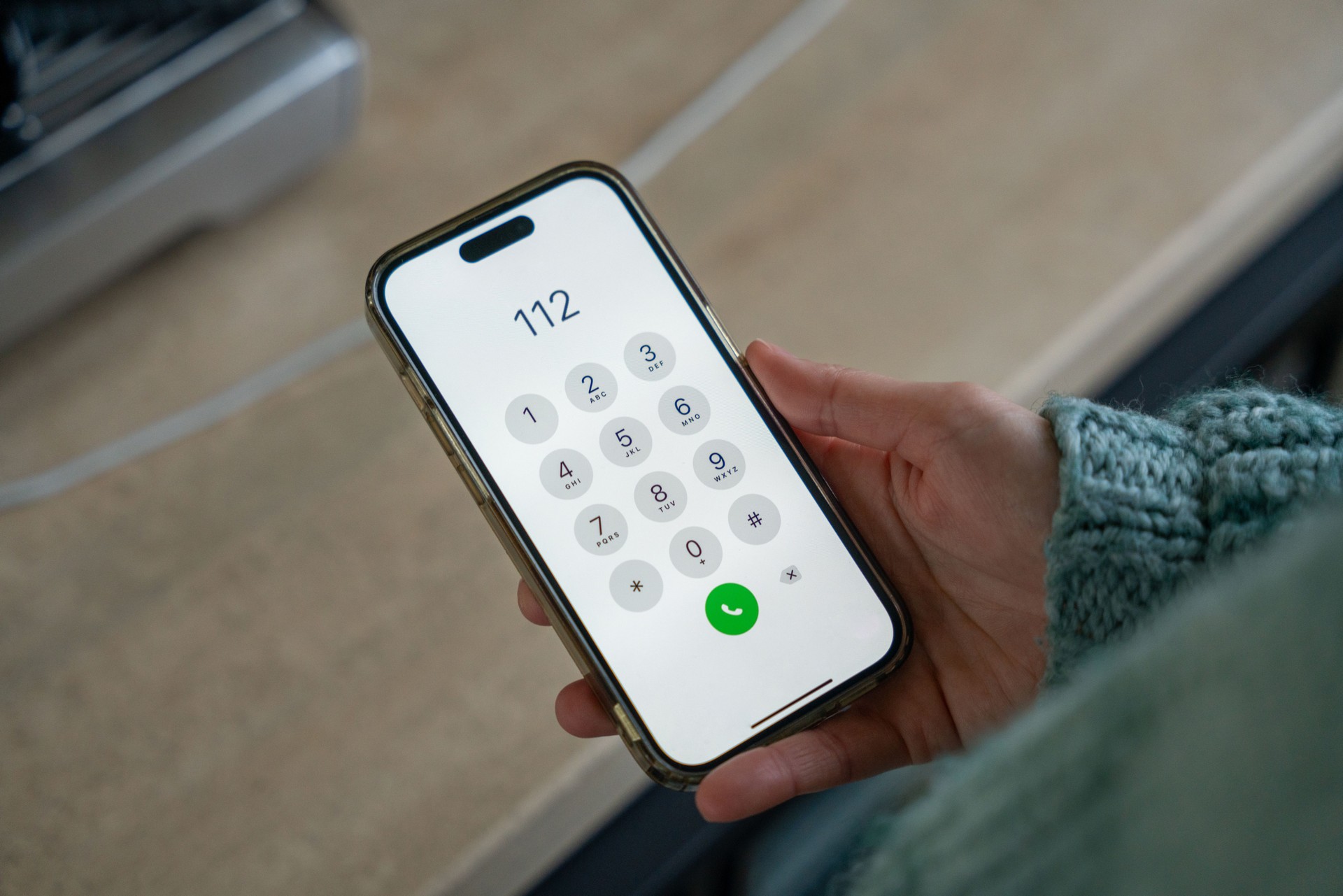 Woman calling emergency number 112 on smartphone